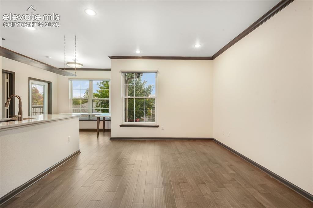 Image 8 of 50: Open-concept interior featuring wood-finish flooring, recessed lighting, do