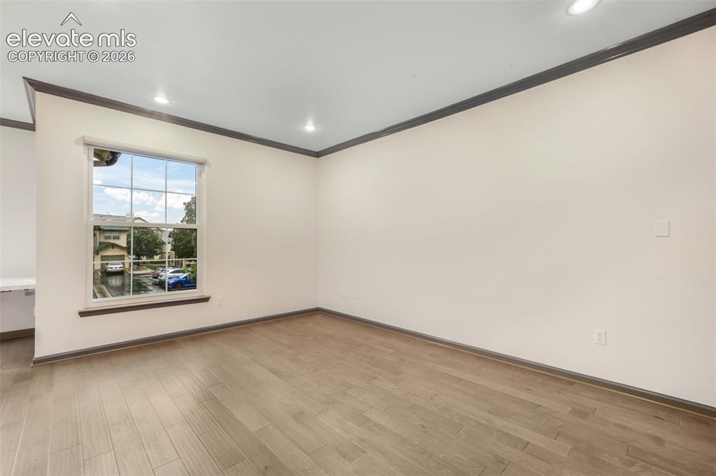 Image 9 of 50: Wood-finish flooring, recessed lighting, single-hung window with grid patte