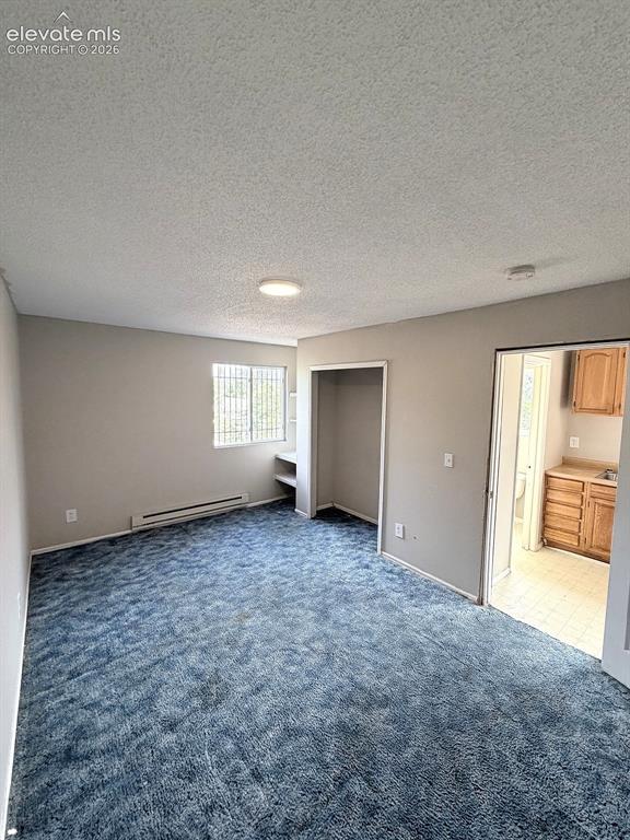 Image 11 of 14: Wall-to-wall carpeting, built-in shelving, and a window with security bars