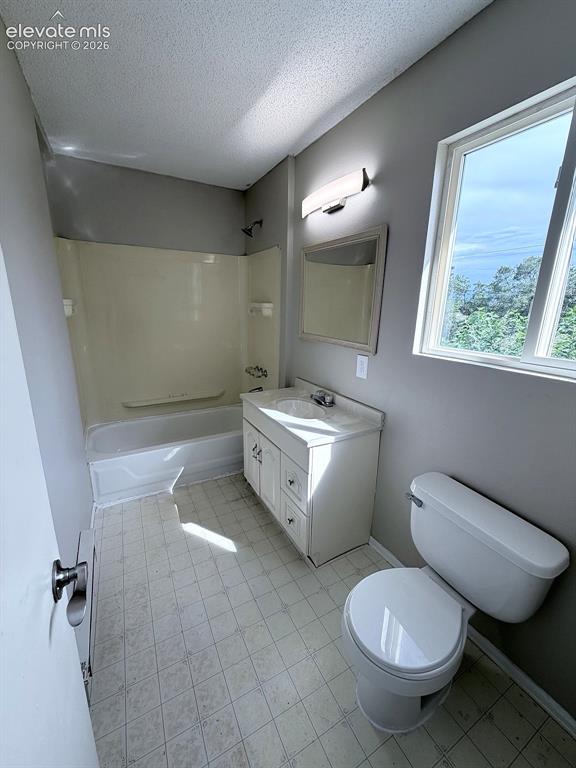 Image 13 of 14: Bathroom with a single vanity, integrated sink, and white cabinetry