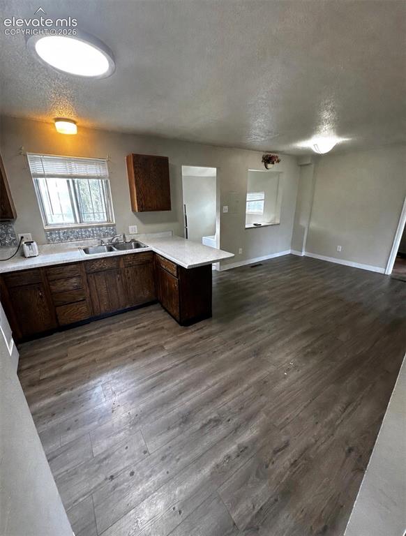 Image 3 of 14: Open-concept living area featuring wood-finish flooring and recessed lighti
