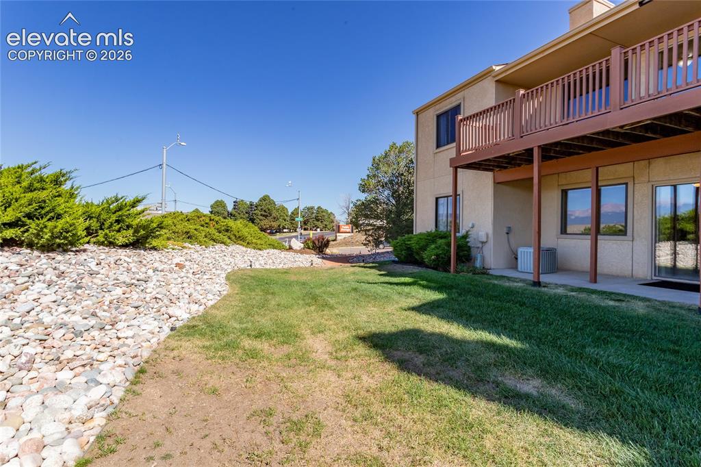 Image 12 of 29: Ground-level patio with sliding glass door access