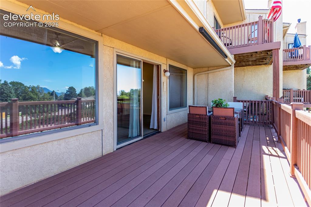 Image 17 of 29: Expansive outdoor deck with composite wood-finish flooring, sturdy wood rai
