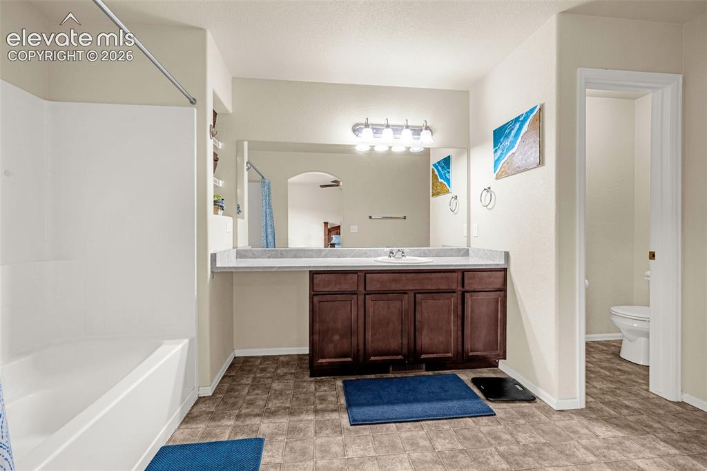 Image 15 of 32: Bathroom featuring a tub/shower combination, a vanity with a single basin s