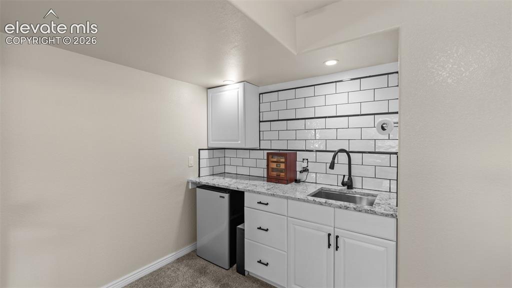Image 13 of 30: Bedroom basement wetbar