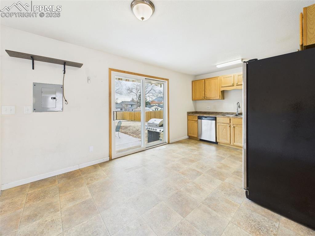 Image 12 of 50: A spacious dining area with tile flooring and ample natural light, position