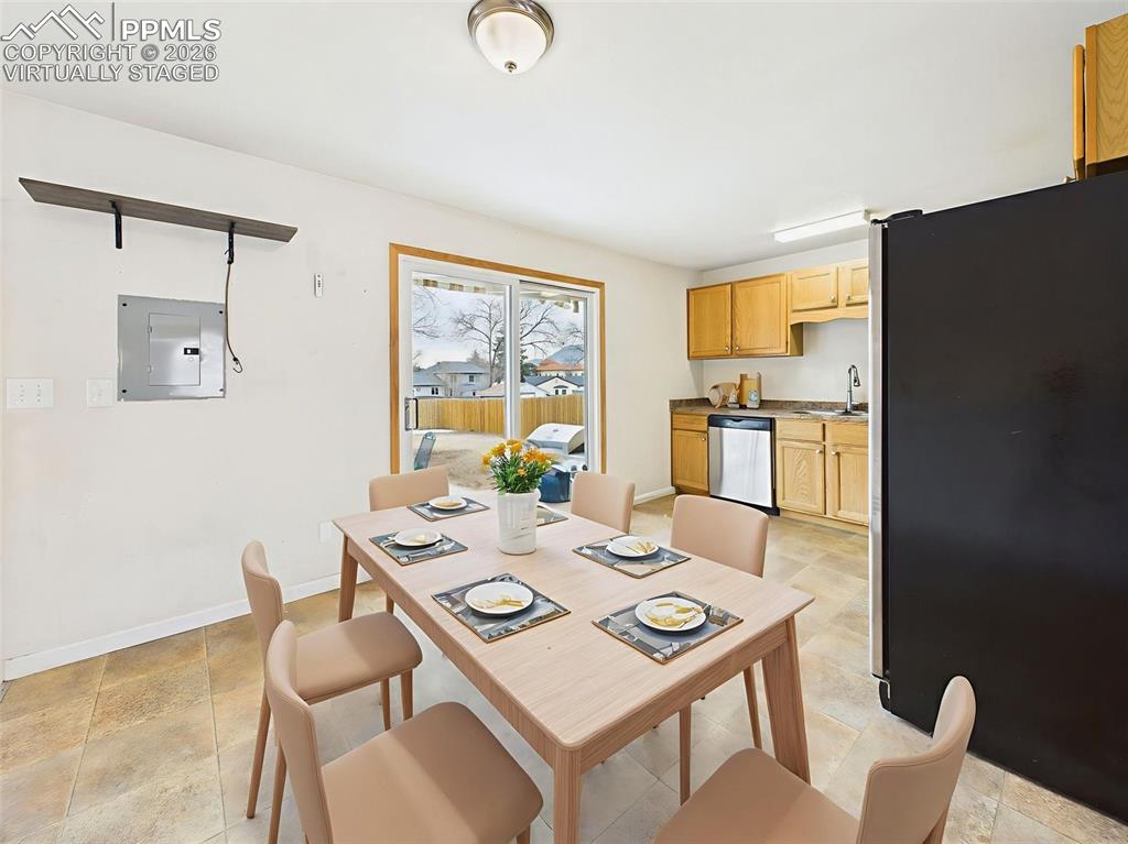 Image 13 of 50: Virtually Staged The eat-in kitchen includes a cozy dining setup with direc