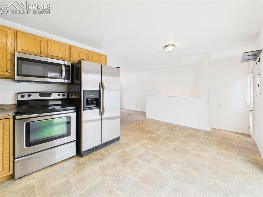 Image 16 of 50: The kitchen is equipped with stainless steel appliances, including a built-