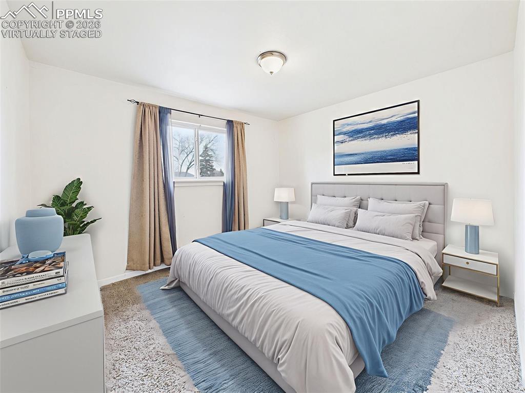 Image 20 of 50: Virtually Staged Bedroom 1 The spacious primary bedroom features soft carpe