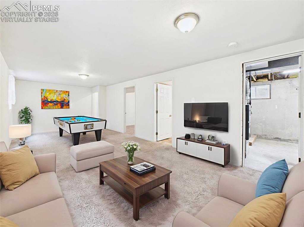 Image 31 of 50: Virtually Staged Virtually staged as a vibrant game and media space, this r