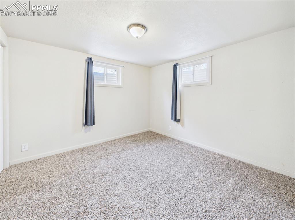 Image 34 of 50: Bedroom 4 Dual windows bring in natural light, while the spacious layout of