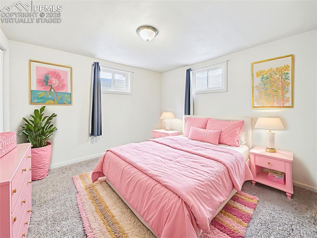 Image 35 of 50: Virtually Staged Bedroom 4 A cheerful, styled space with pink tones, showca