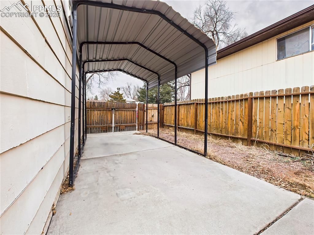 Image 44 of 50: Convenient covered carport provides shaded parking or additional outdoor st