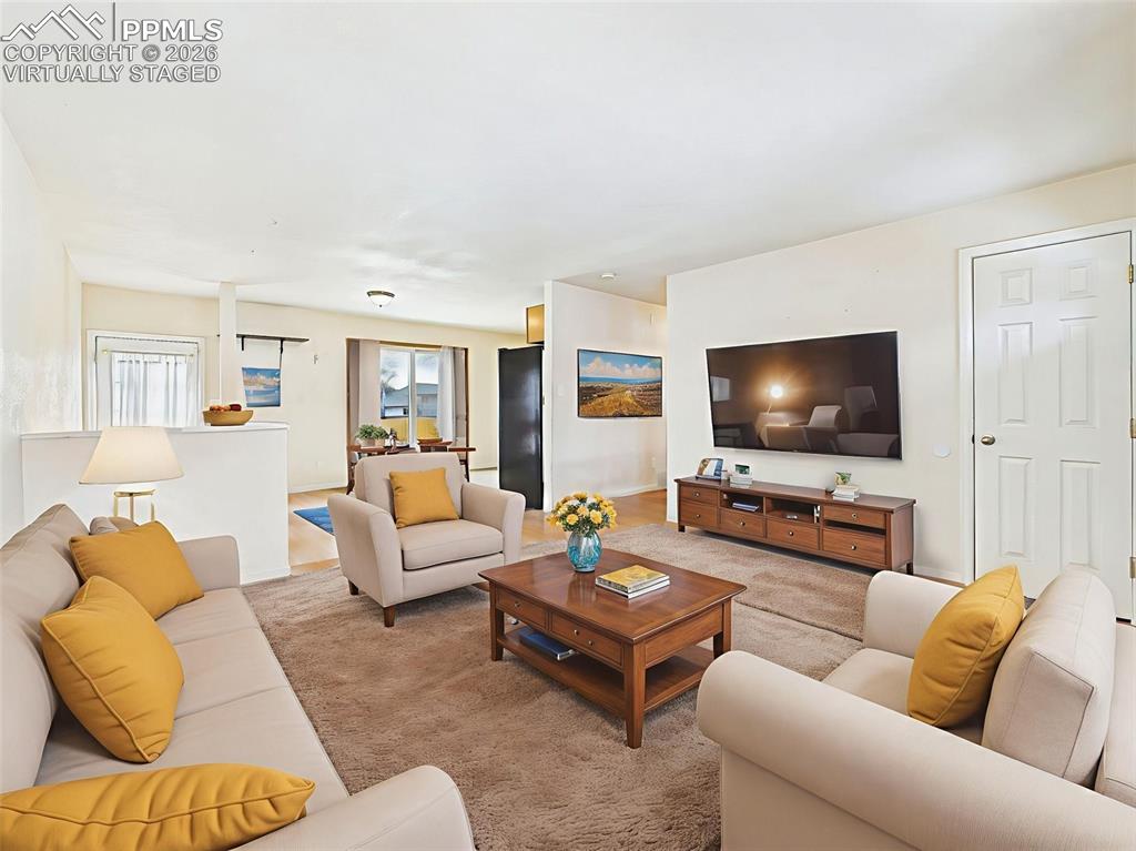 Image 6 of 50: Virtually Staged A wide view from the living space into the dining and kitc