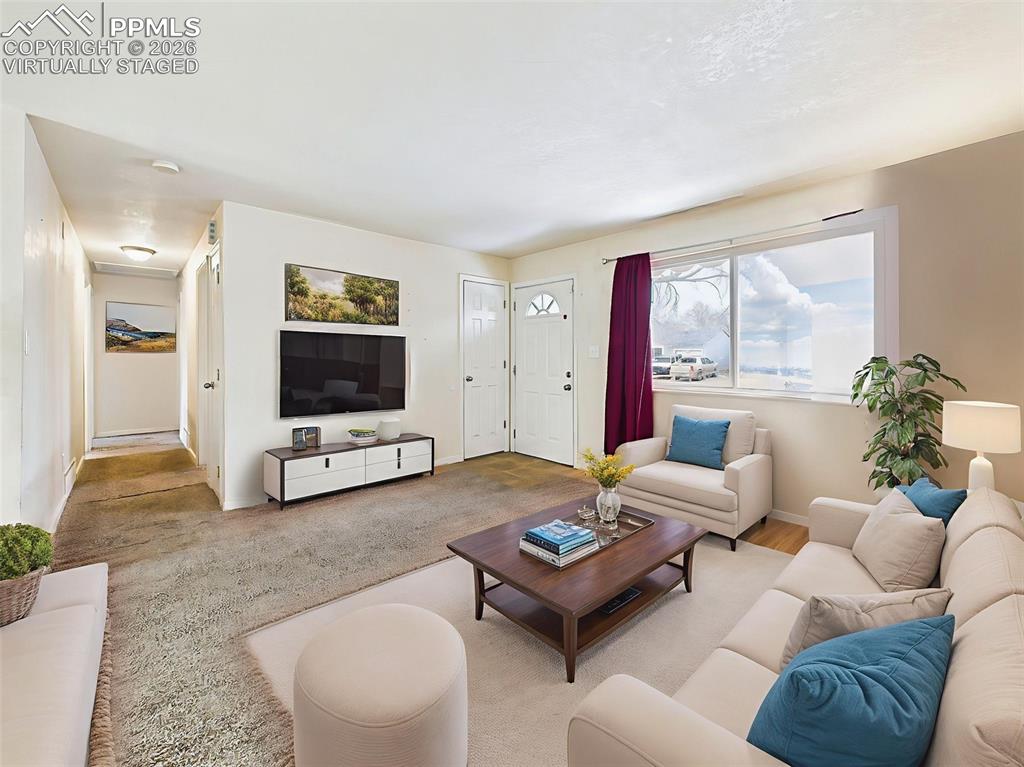 Image 8 of 50: Virtually Staged A second angle of the living room reveals its open flow to