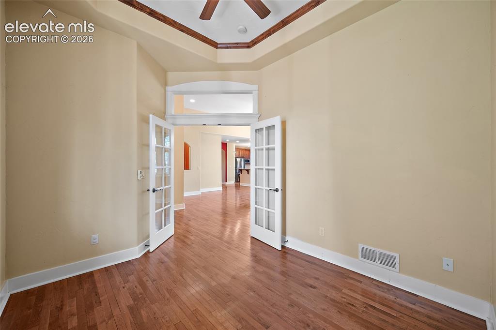 Image 20 of 50: Private office with French doors.