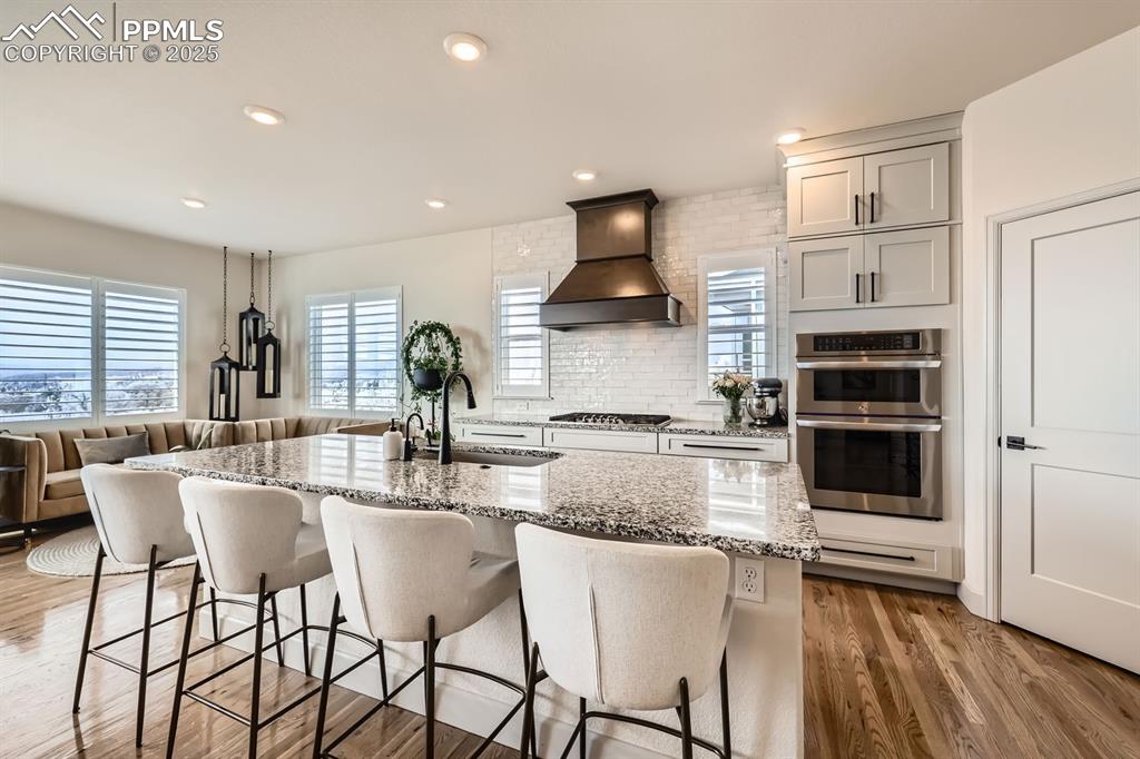 Image 6 of 28: Kitchen featuring appliances with stainless steel finishes, premium range h