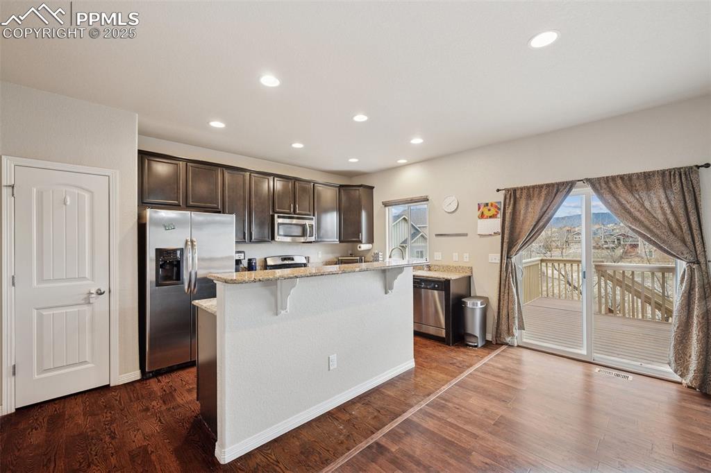 Image 6 of 48: Eat in kitchen walks out to deck.