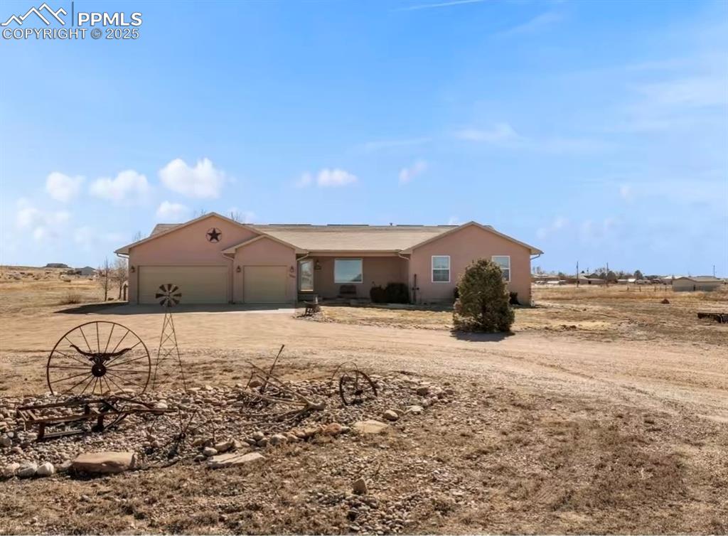 Image 3 of 9: Single story home featuring driveway, an attached garage, and stucco siding