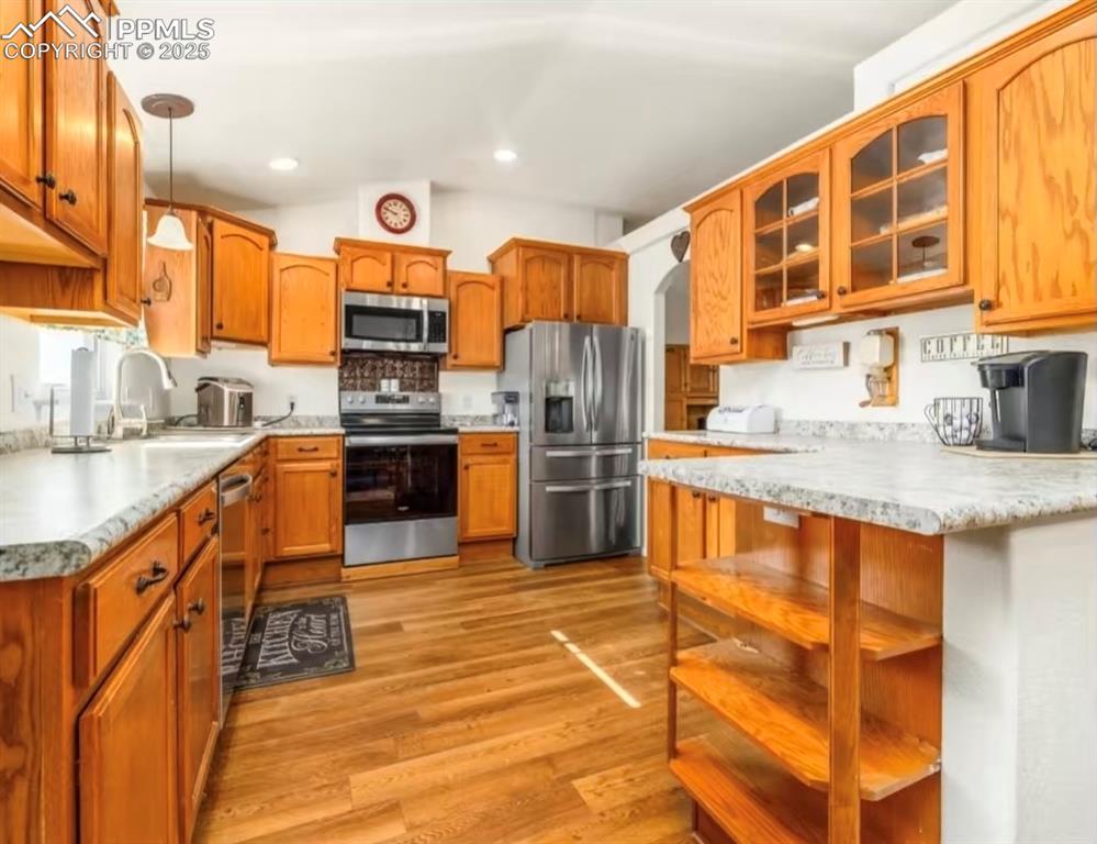 Image 7 of 9: Kitchen featuring pendant lighting, appliances with stainless steel finishe