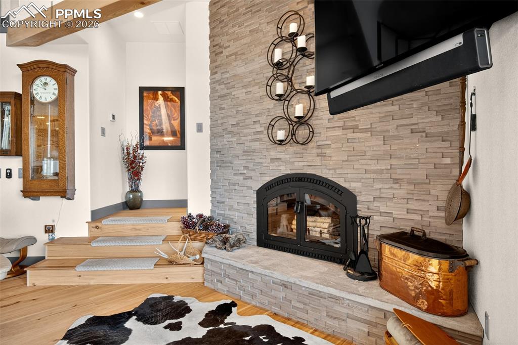 Image 13 of 50: Wood burning Xtrordinair fireplace off the living room