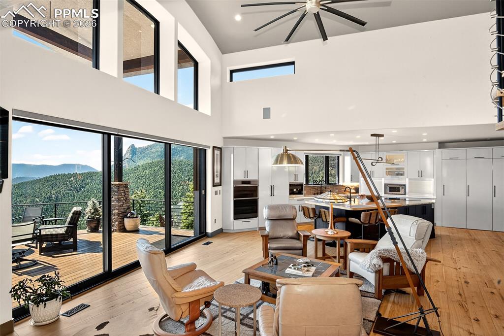 Image 14 of 50: Open concept living room with wood burning fire place