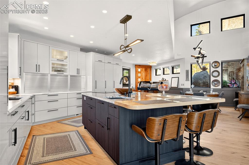 Image 25 of 50: Kitchen highlighting the sleek, custom cabinetry