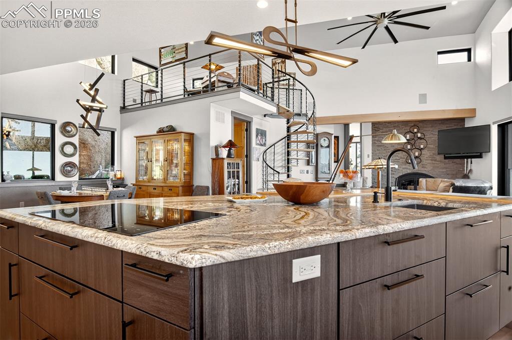 Image 28 of 50: Kitchen with custom light fixtures looking out to loft, living room and din