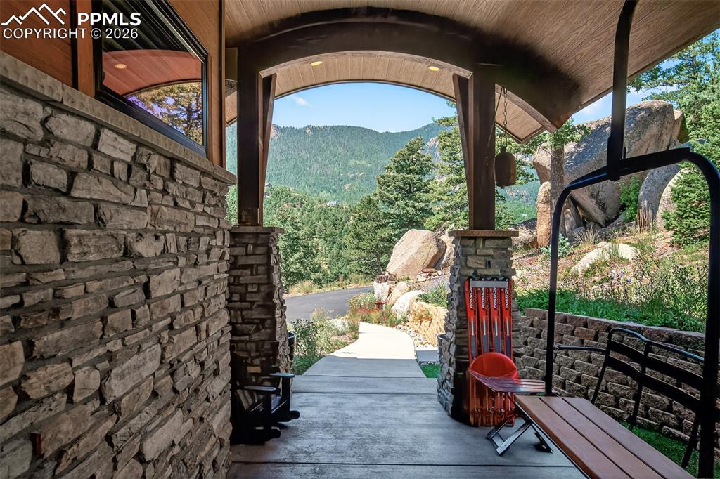 Image 3 of 50: Covered front patio with custom ski lift chair seat (from Angel Fire Resort