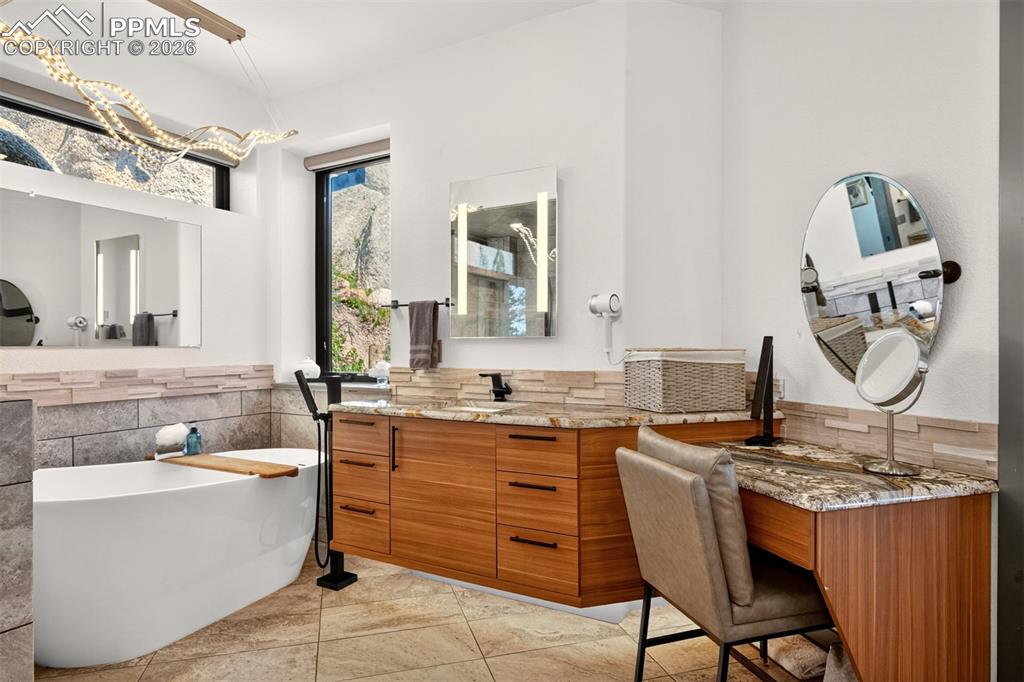 Image 32 of 50: 5 piece en suite primary bathroom with powder area all encased with granite