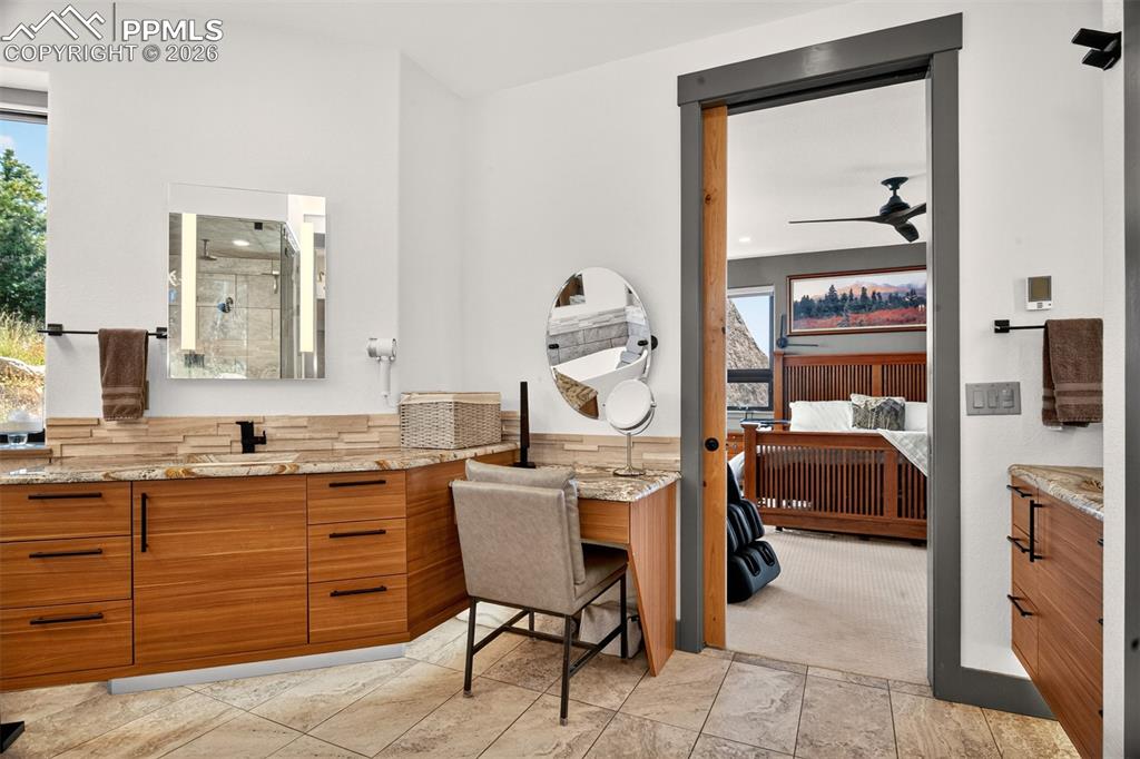 Image 33 of 50: Primary bathroom with granite countertops a powder area, plenty of storage