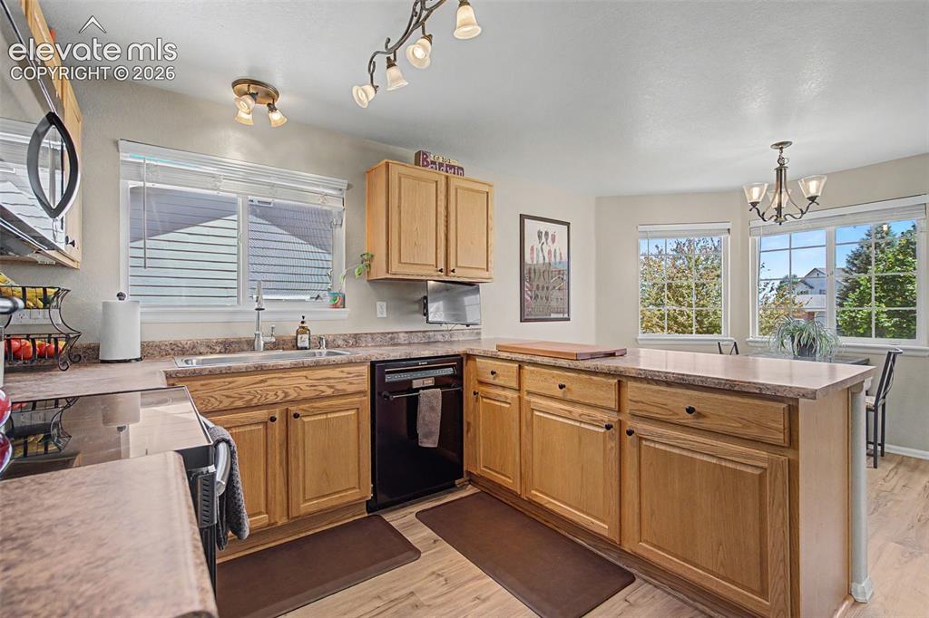 Image 10 of 39: The spacious kitchen features a breakfast nook at the bay window, a pantry,