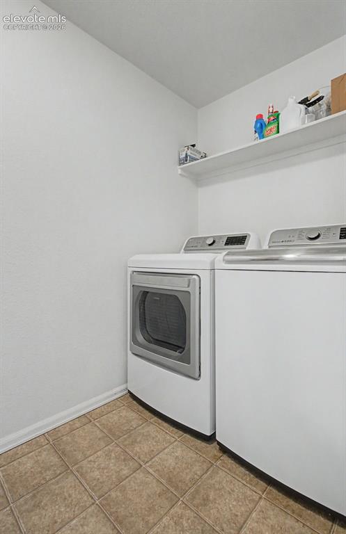 Image 26 of 39: Spacious laundry room with tons of storage space