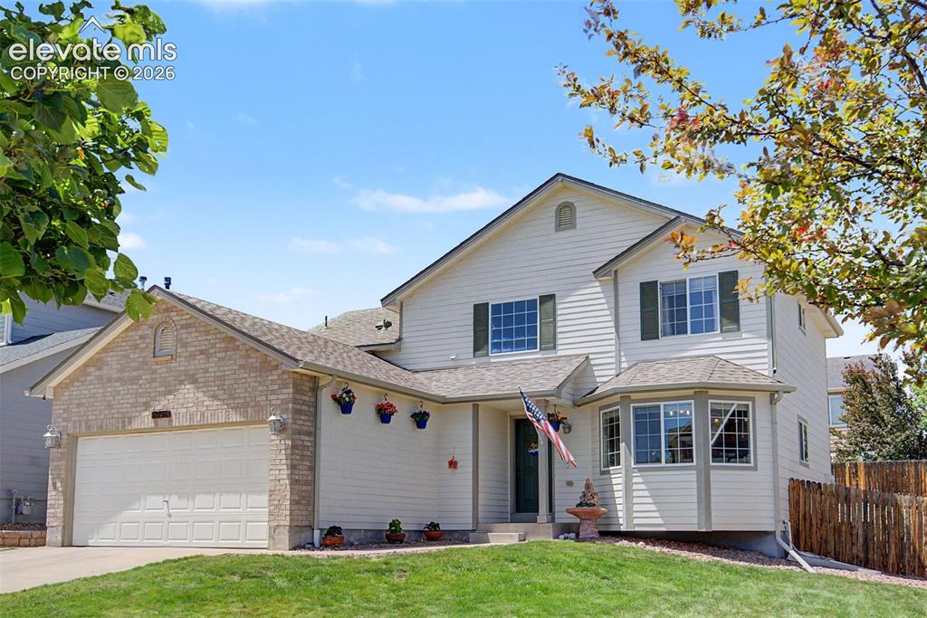 Image 4 of 39: Beautiful trees and landscaping give welcoming curb appeal