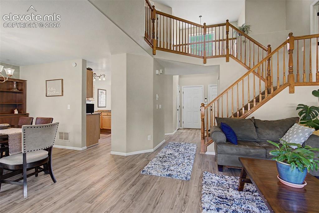 Image 5 of 39: The open floor plan features upgraded wide plank laminate flooring througho