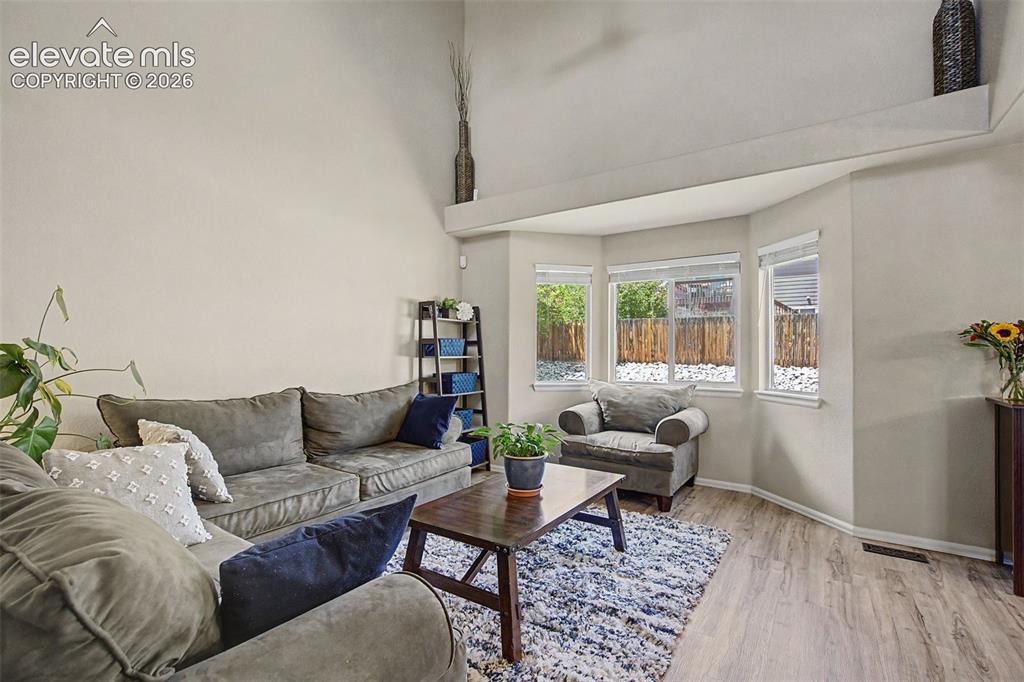 Image 6 of 39: A vaulted ceiling and bay window provide gorgeous light