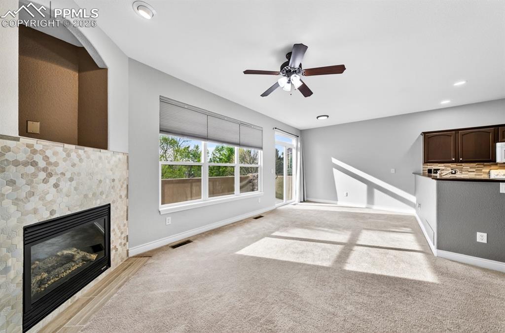 Image 2 of 21: Living room with gas fireplace and walkout
