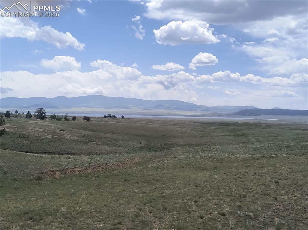 Image 19 of 20: View of mountain backdrop with rural landscape