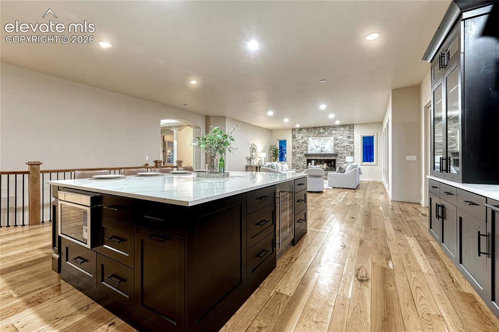 Image 8 of 48: Featuring a large quartz island and breakfast bar.