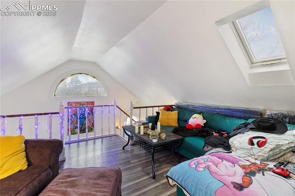 Image 14 of 34: Bright loft featuring a skylight; presently configured as a living room!