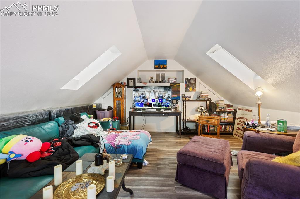 Image 15 of 34: Bright loft featuring a skylight; presently configured as a living room!