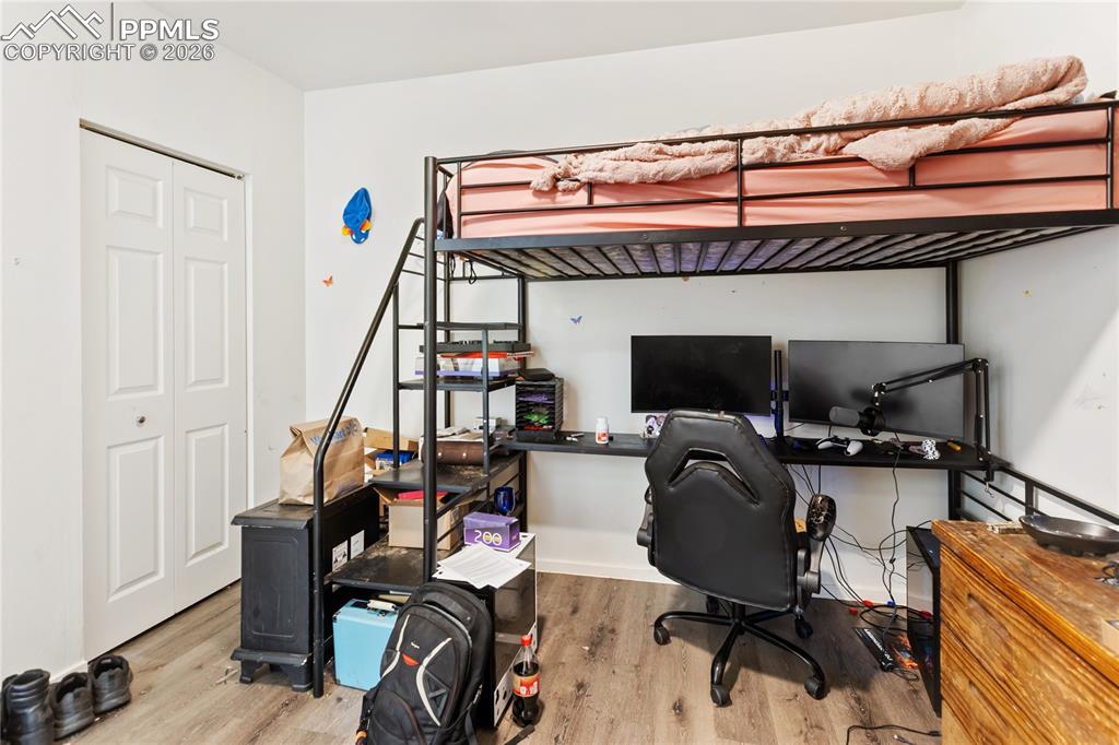 Image 17 of 34: The second bedroom has wood-style finished floors and a closet!
