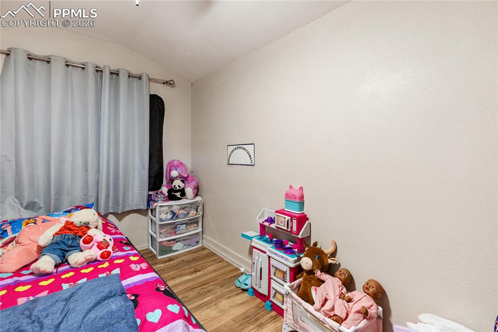 Image 29 of 34: The second bedroom features wood-finished floors!