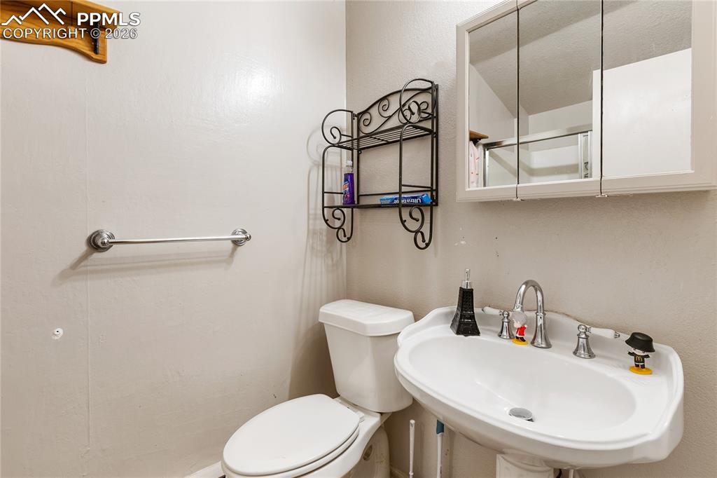 Image 30 of 34: The bathroom has a toilet and a sink!