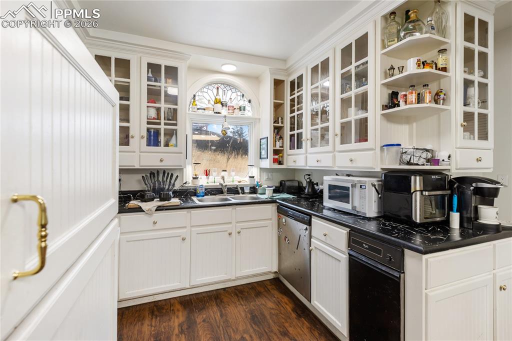 Image 4 of 34: The kitchen has white glass French doored cabinetry, White appliances, and 