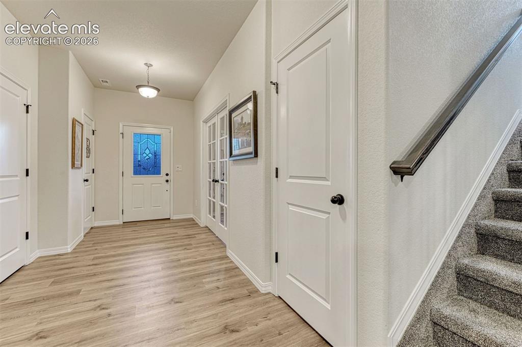 Image 10 of 49: Greeting guest in this large entry with half bath