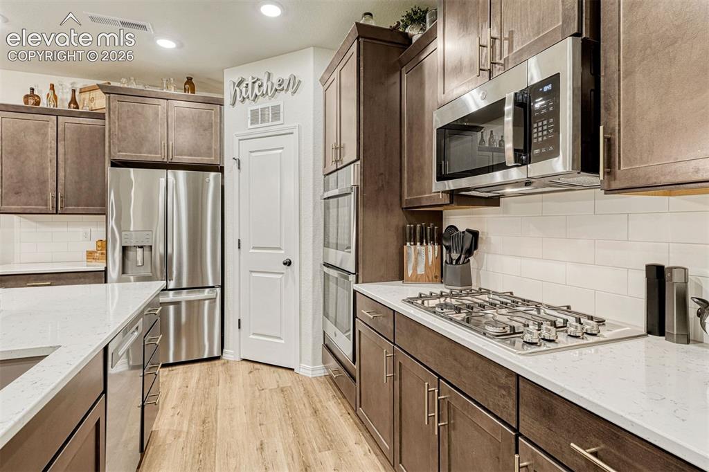 Image 18 of 49: Walk in Pantry, Gas cook top and Double wall ovens plus microwave
