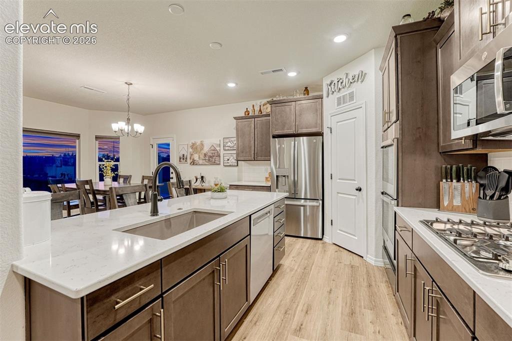 Image 19 of 49: Deep basin sink and dishwasher conveniently located in the island breakfast