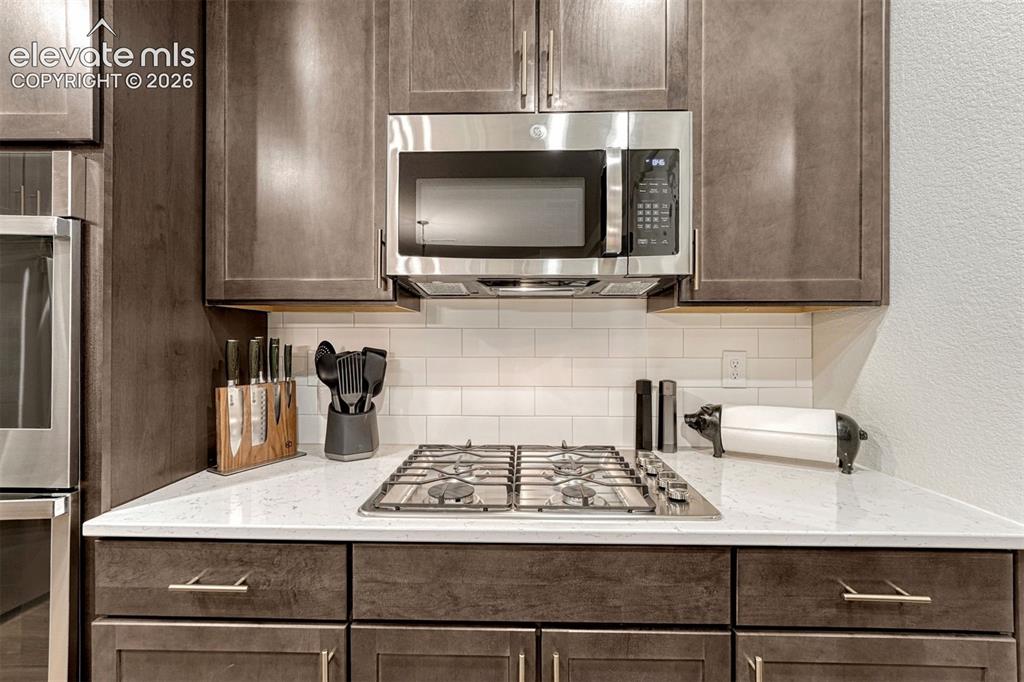 Image 22 of 49: Five burner gas cook top and microwave