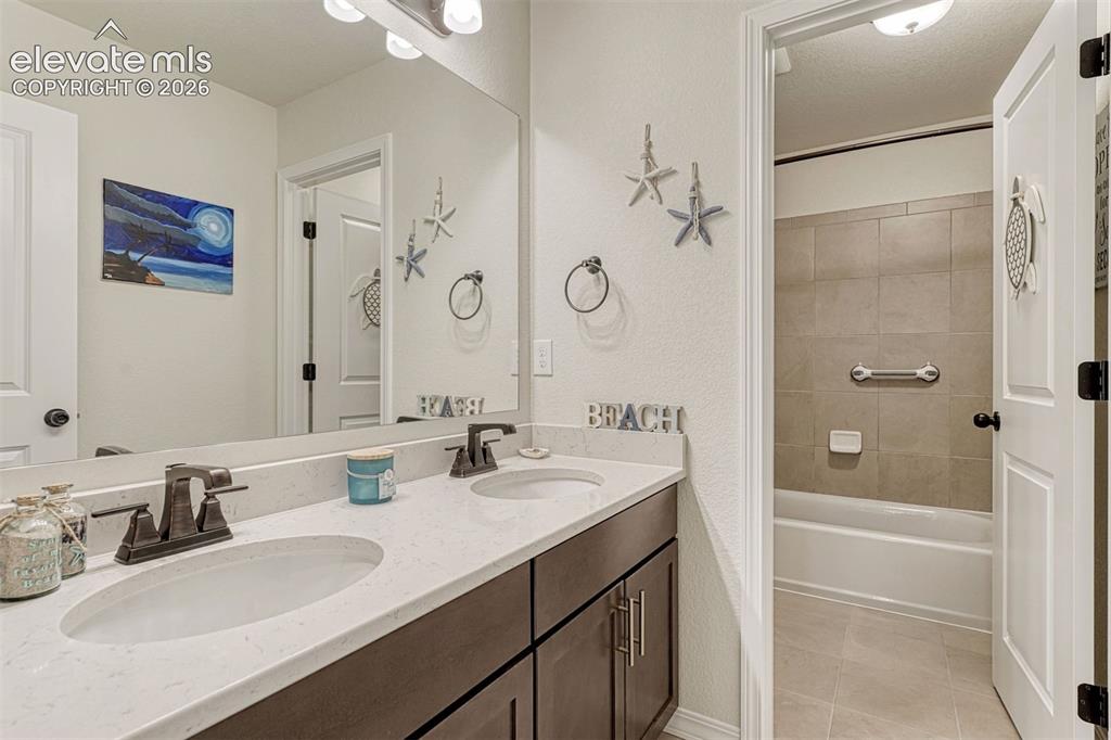 Image 35 of 49: Dual vanity and separate tub/shower room